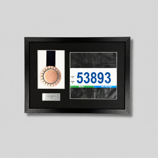 a framed display with a medal and a race number.