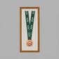 a framed medal with a green ribbon and a copper-colored medal with the year "2026" on it.