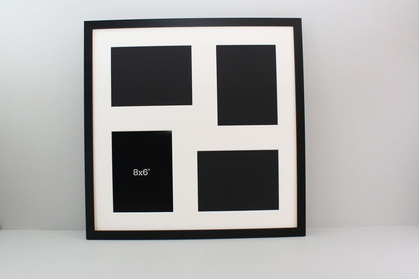 a black and white picture frame with four squares