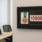 a framed collage of two framed medals and a framed number on a wall.