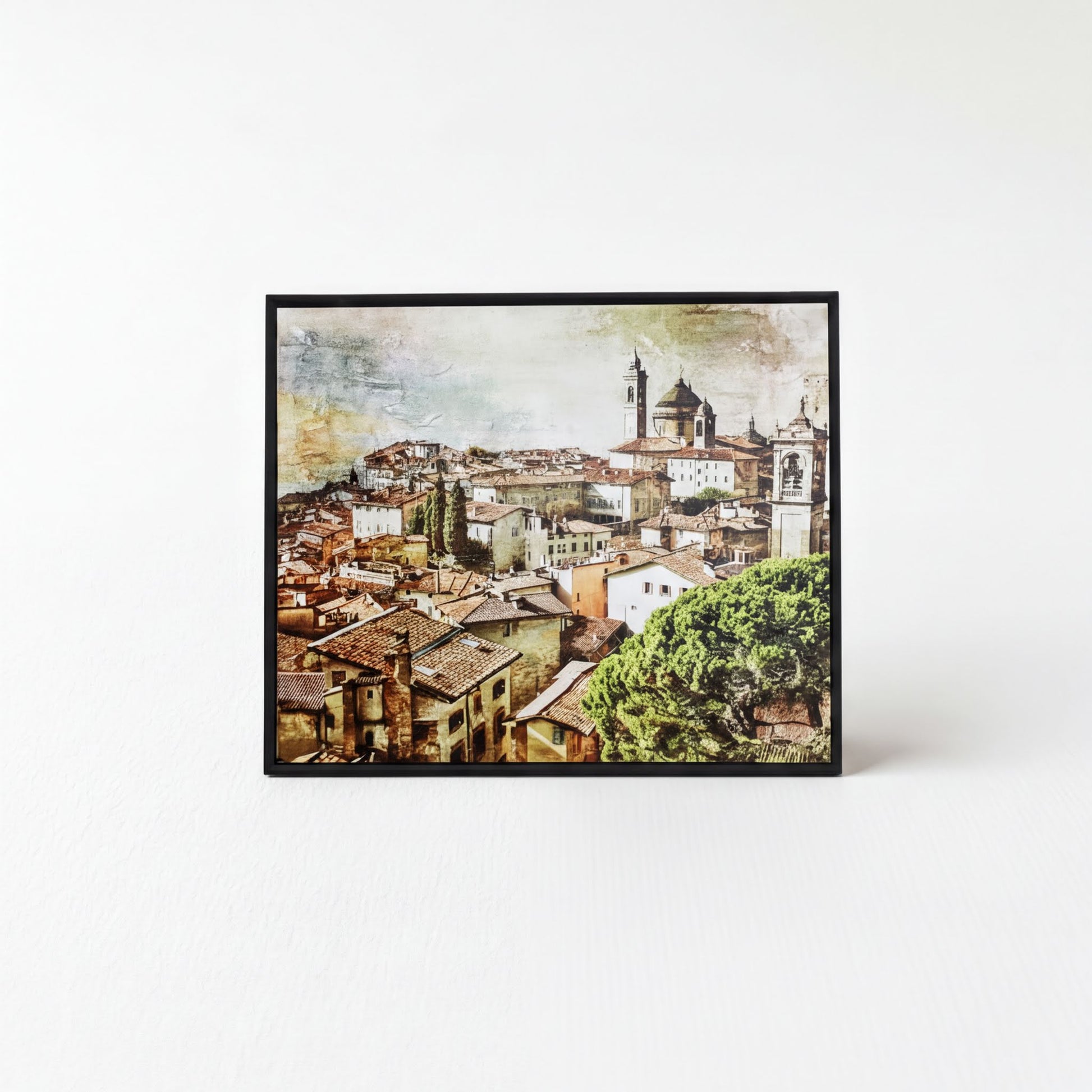 The image is a framed print depicting a cityscape with a church and other buildings in the background.