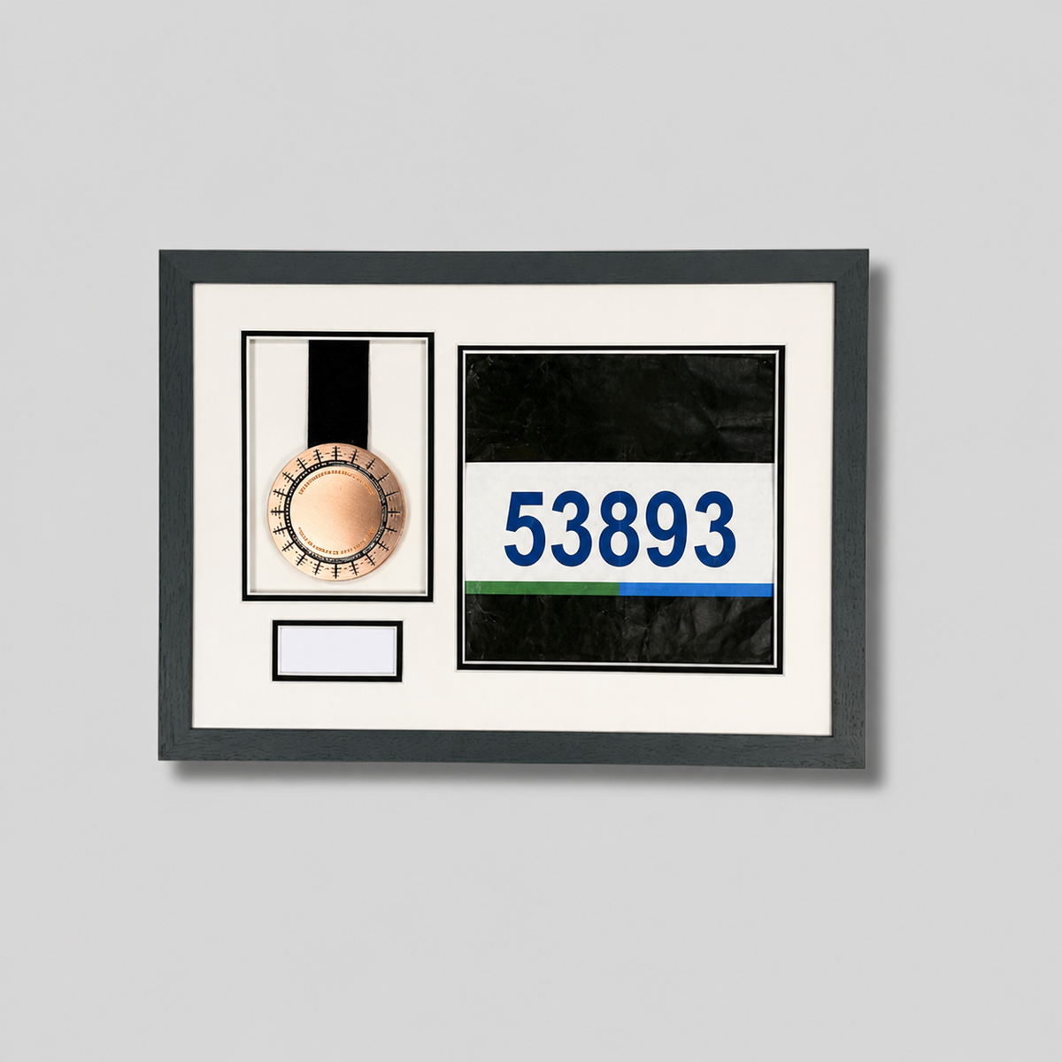 a framed display with a medal and a number on it.