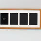 a picture frame with a picture of three black squares