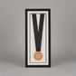 a framed medal with a black ribbon, set against a plain gray background.