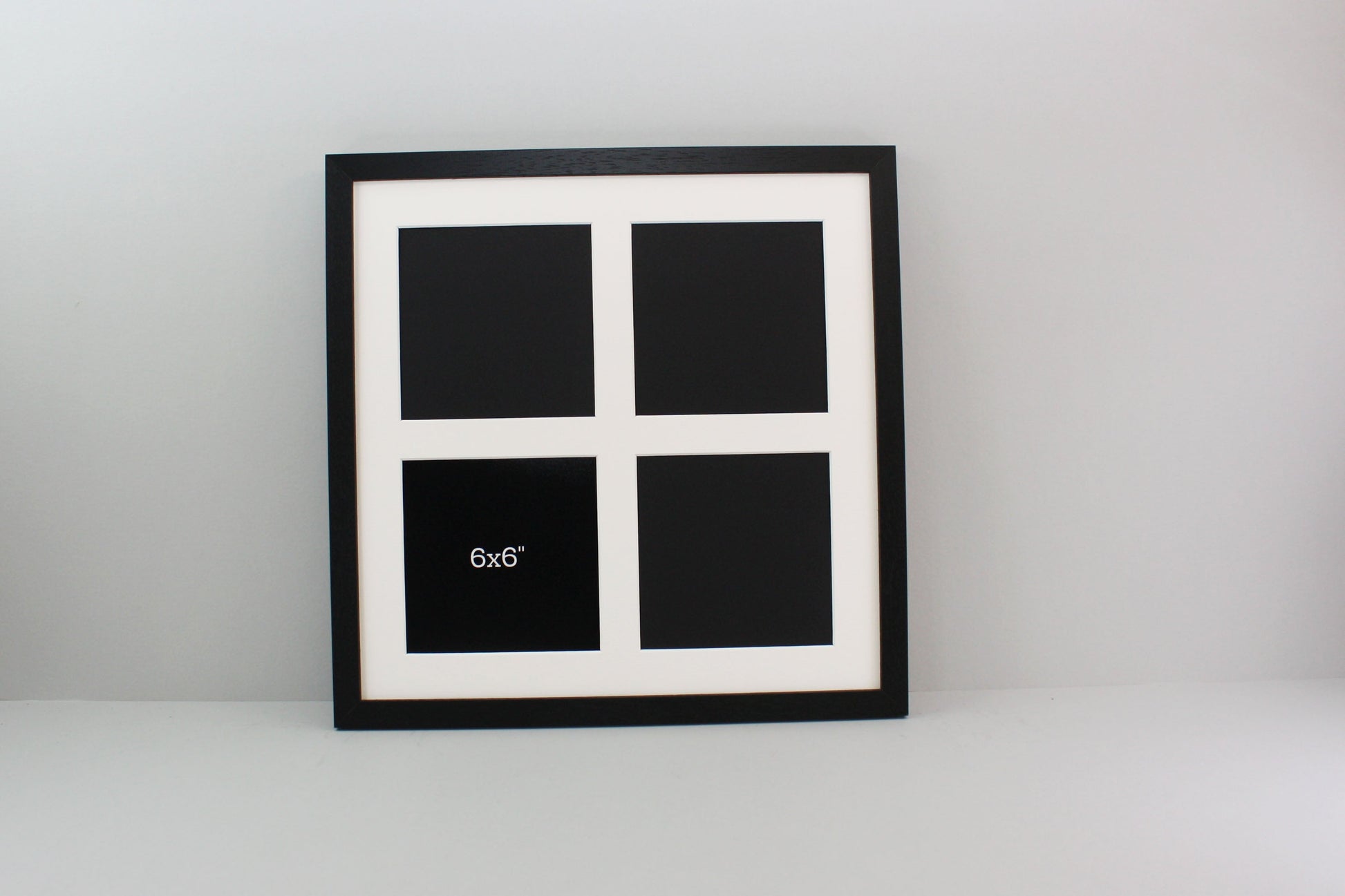 a black and white picture frame with four squares