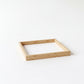 A simple, empty wooden frame sits on a plain white background.