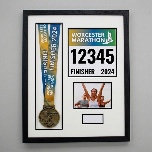 a framed collage of a medal, a photo, and text related to the Worcestershire Marathon.