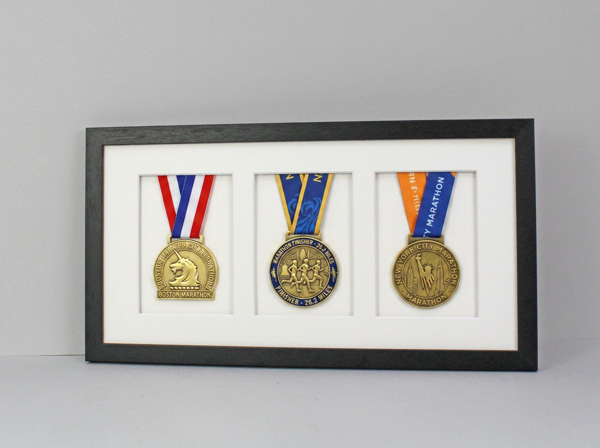 A framed display of three medals, each with a unique design and color, arranged in a row.